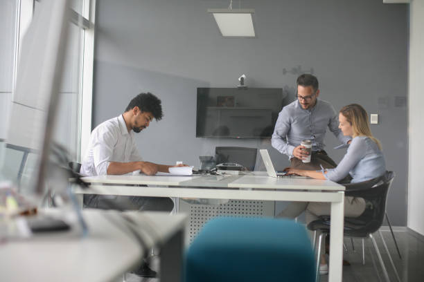 istock Business people using technology and checking document. Business people at the office. 803057454