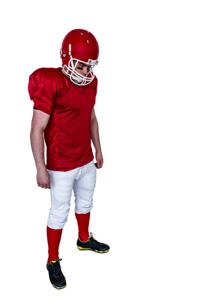 istock Unsmiling american football player looking down 803057676
