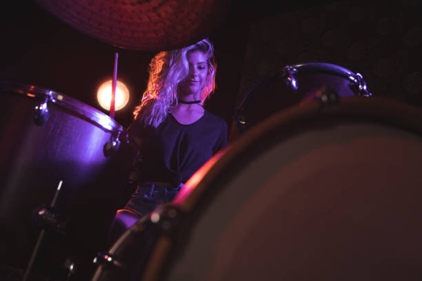 istock Beautiful drummer performing in illuminated nightclub 803057756