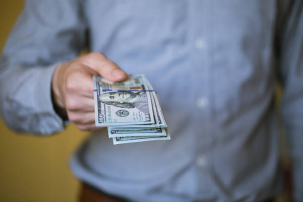 istock Businessman holding money in his hands 803062246