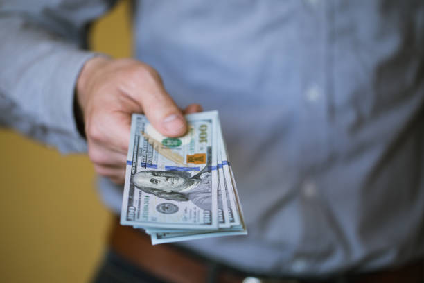 istock Businessman holding money in his hands 803062252