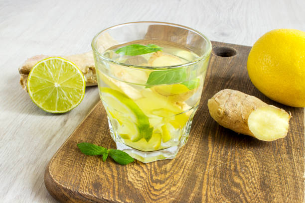 istock Ginger ale soda with lemon, mint, ginger and ice over rustic wooden background 803062850