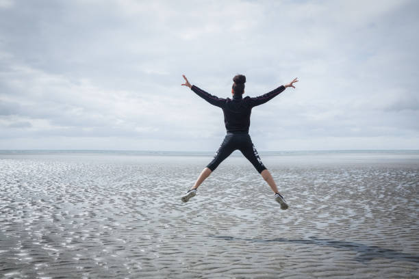 istock Fit girl leaping on cold day 803063096
