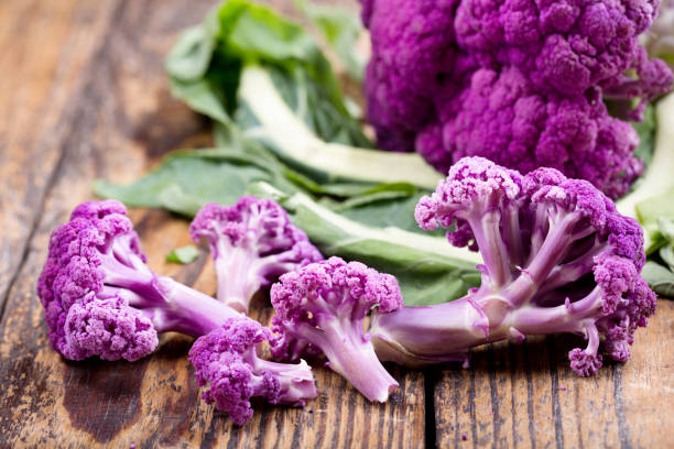 istock purple cauliflower on a wooden table 803063340