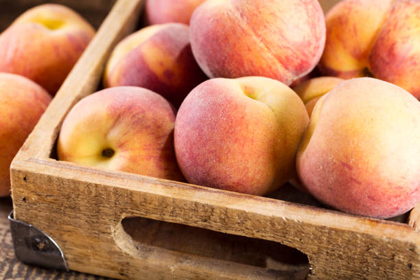 istock fresh peaches in a wooden box 803063448