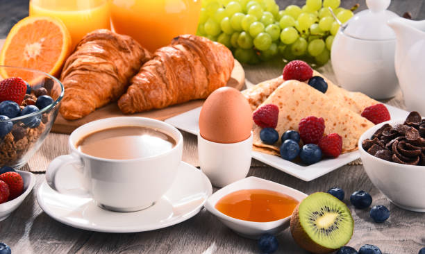 istock Breakfast served with coffee, juice, croissants and fruits 803065096