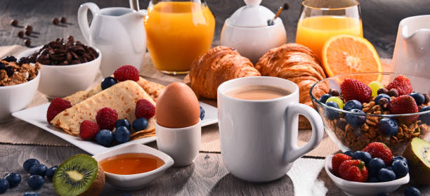 istock Breakfast served with coffee, juice, croissants and fruits 803067714