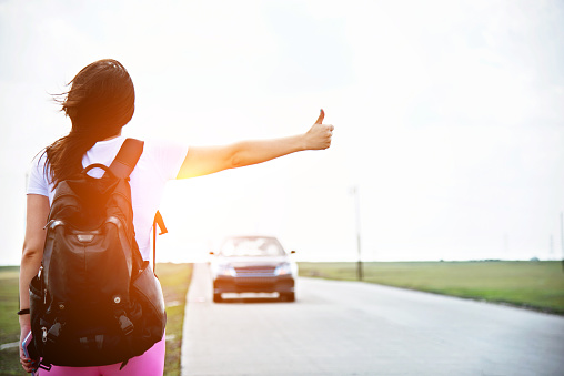 Woman thumb up for a ride