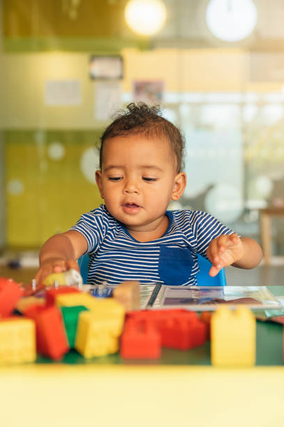 istock Happy baby playing with toy blocks. 803077754