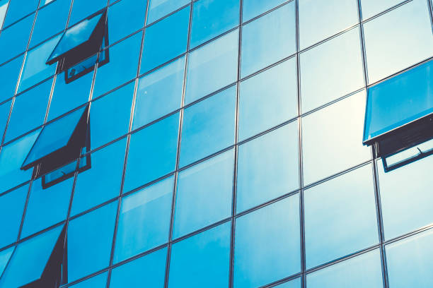 istock Closed and opened windows on a corporate business building 803080068