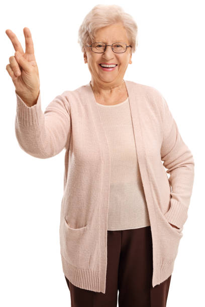 istock Joyful elderly woman making a victory sign 803083654