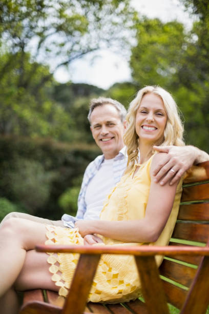 istock Happy couple sitting on a bench 803092042