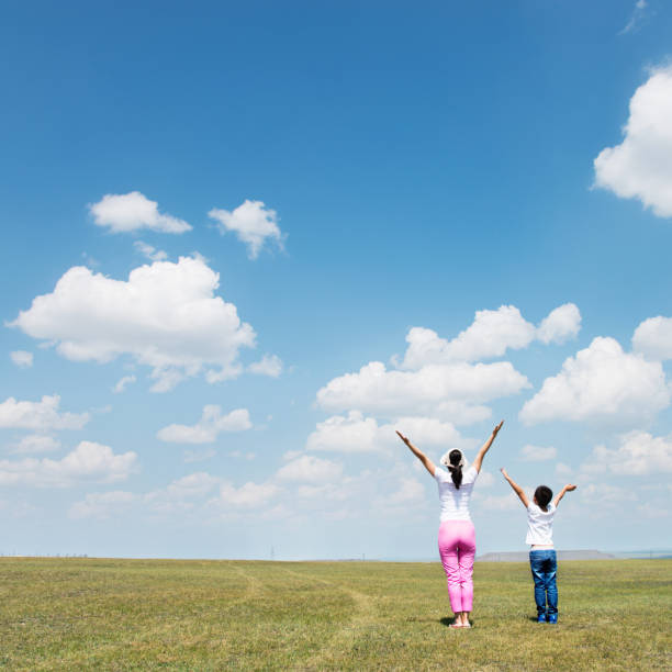 istock Mother and son relaxing in the field 803095054