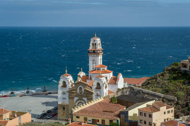 istock Basilica de Candelaria and Guanche statues at ocean shore 803095632