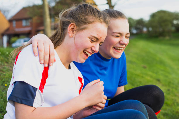 Teen Girls Having Fun at Training Teen girls laughing on the rugby pitch at training! rugby team stock pictures, royalty-free photos & images