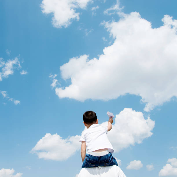 istock Son and father play paper airplane 803101730