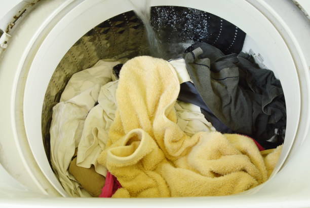 istock water flowing on cloth in washing machine drum 803105104