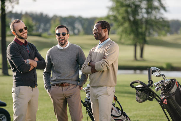 istock happy multiethnic golfers spending time together in golf course 803109082