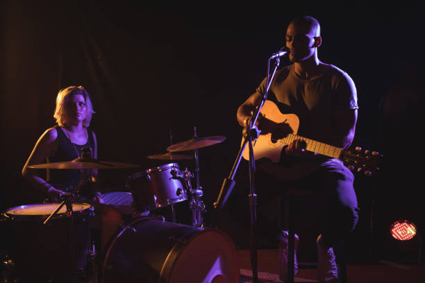 istock Singer performing with drummer in nightclub 803113114
