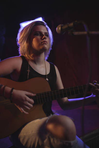 istock Singer practicing with guitar in nightclub 803113360