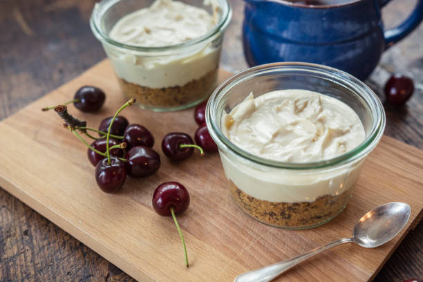Making cheesecake with cherries in a jar. stock photo