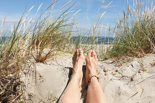 Stretch your feet in a relaxed manner on vacation. Water at the mountain lake.