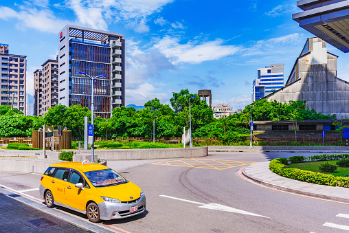 Taipei: This is a Taipei taxi waiting outside Guandu mrt station fior a passenger with modern city buildings in the background on May 29, 2017 in Taipei