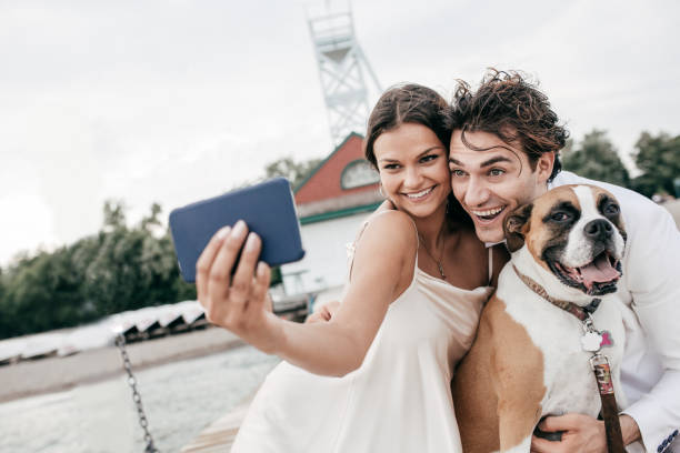 Just engaged couple taking selfie with dog