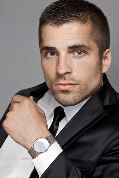 istock Suited man with wristwatch, portrait 803137642