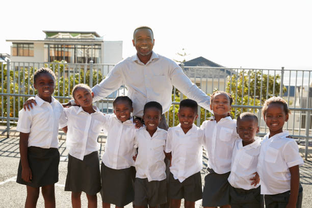 istock Teacher and elementary school kids in playground, portrait 803138136