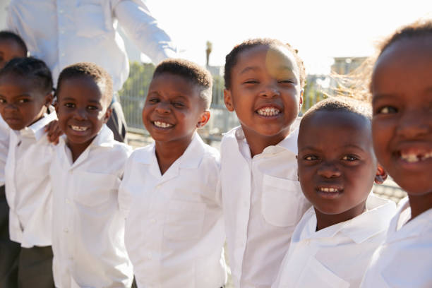 istock Elementary school kids smiling to camera in playground 803138148