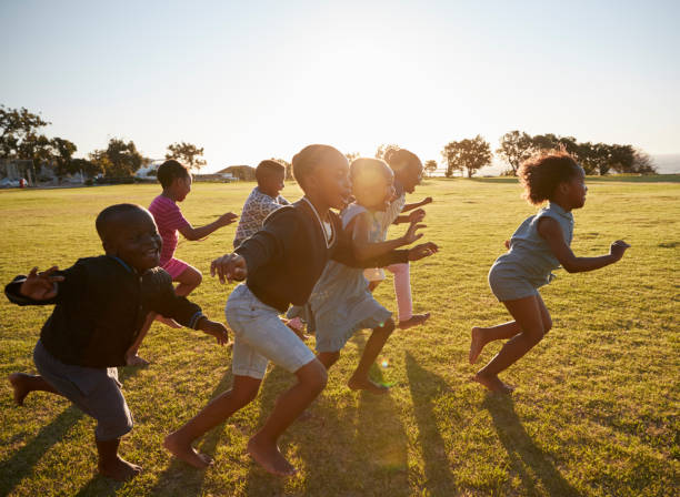 istock Elementary school kids running together in an open field 803138204