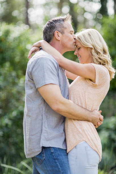 istock Husband kissing wife on the forehead 803138768