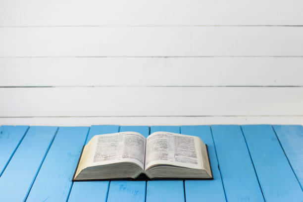 istock Bible on the old table. Beautiful background 803139594