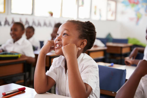 istock Girl listening during a lesson at an elementary school 803141070