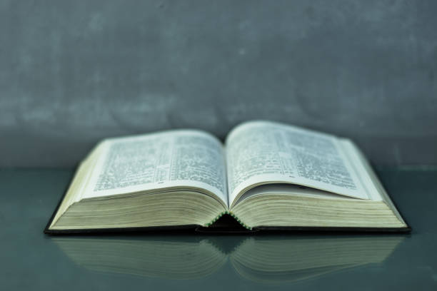 istock Bible on the old table. Beautiful background 803141120