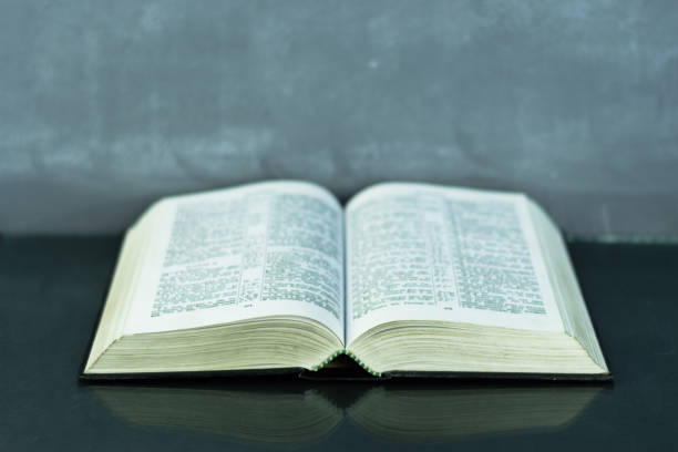 istock Bible on the old table. Beautiful background 803143226