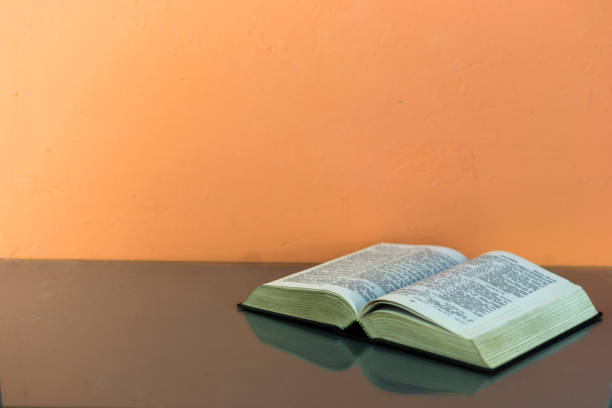 istock Bible on the old table. Beautiful background 803144284