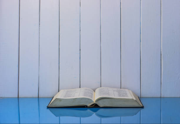 istock Bible on the old table. Beautiful background 803145476