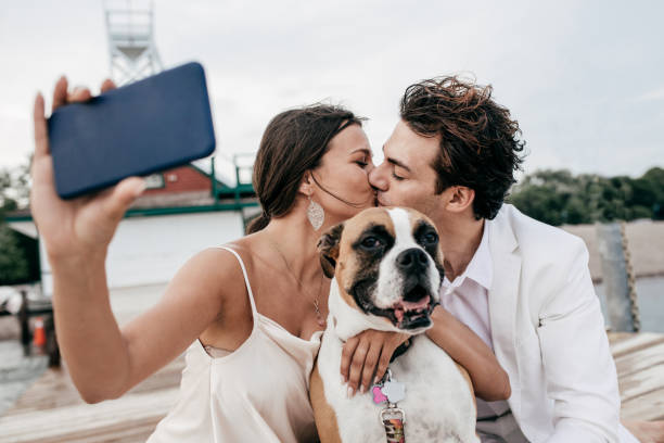 istock Just engaged couple taking selfie with dog 803150070