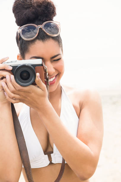 istock Pretty hipster in bikini taking picture 803154874