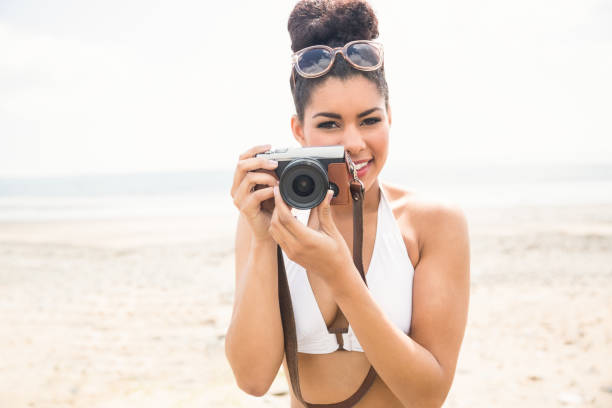 istock Pretty hipster in bikini taking picture 803154948