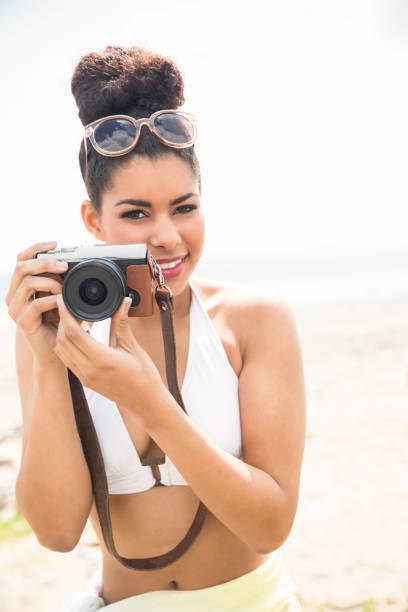 istock Pretty hipster in bikini taking picture 803154970