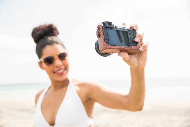 istock Pretty woman in bikini taking selfie 803155150