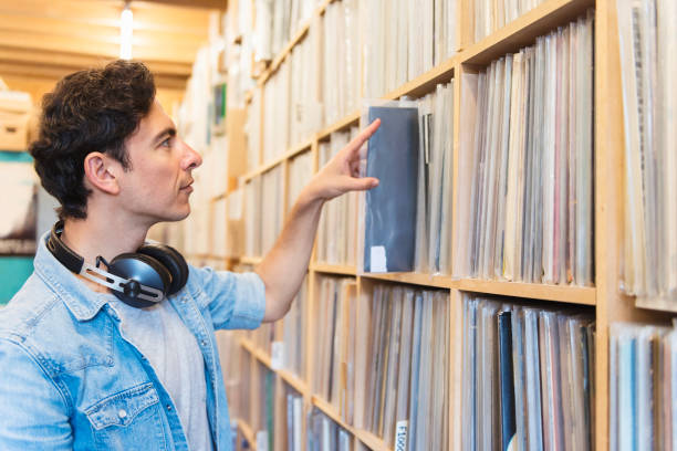 istock Audiophile man at the record store 803155230