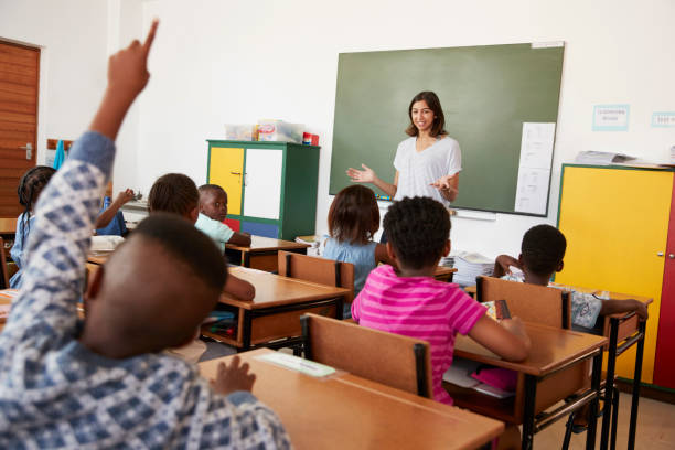 istock Female teacher in front of an elementary school class 803164386