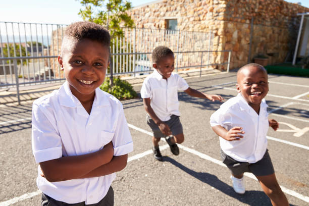 istock Young African schoolboys running in school playground 803172044