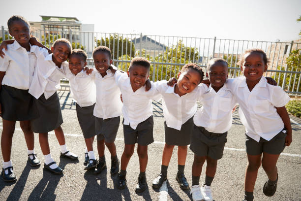 istock Elementary school kids in Africa posing in school playground 803172314