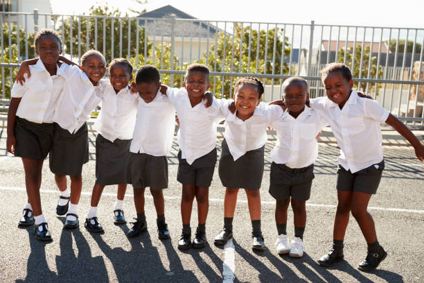 istock Elementary school kids in Africa posing in school playground 803172352