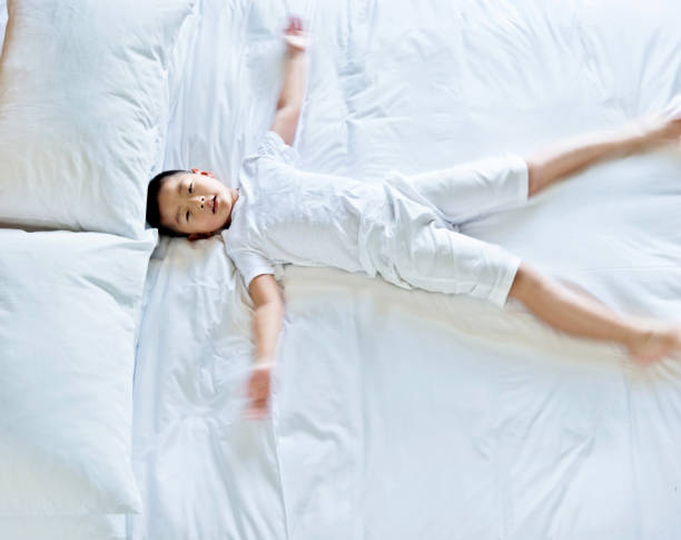 istock Little boy waking up in bed 803192902